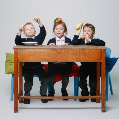 3 school children on a desk